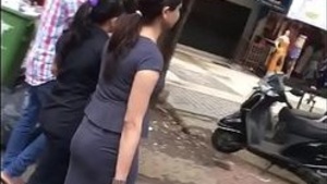 Watch a hot Indian girl in a tight skirt show off her cute butt