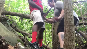 Watch a stunning white girl give a blowjob to a black guy in the woods