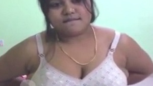 Watch a curvy Indian woman strip down and flaunt her big boobs