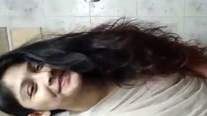 Nude Indian girl takes a bath in sari in bathroom